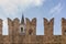 The bell tower of the church of Santa Croce di Fontanellato, Parma, Italy, seen through the battlements of the castle