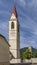 The bell tower of the church of Santa Maria Assunta and the Frohlich tower in the historic center of Malles Venosta, Italy