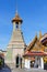 Bell tower decorated with multicolored mosaics and located next to the Phra Ubosot Chapel on the territory of the Temple of the