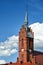 the bell tower of the historic gothic church and roofs made of red tiles in the village of Bledzew