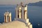 Bell tower of old white church above the beautiful blue sea, Oia