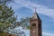 Bell tower of Our Lady Immaculate Conception church in neo-Romanesque style against blue sky