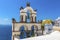The bell tower of a traditional Greek church overlooking the caldera in the village of Oia, Santorini