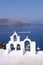 Bell tower of white church above blue sea, Santorini, Greece.
