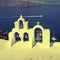 Bell tower of white church above blue sea, Santorini, Greece.