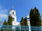 Bell tower with white walls, blue dome and golden spire of Temple of Prophet Elijah in Sumy