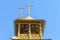 The bell tower of a wooden Orthodox Christian church. Crosses on the domes.