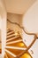 Bellagio, Italy - 07 june 2020: Staircase with illuminated steps and rope railings in a house with white walls.