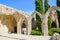 Bellapais, Cyprus - Oct 4th 2018: Ruins of historical Bellapais Abbey with ancient walls and arches. The medieval monastery is