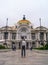 Bellas artes photographer person traveler tourist in front of the building taking a photo and admiring looking at the building