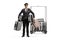 Bellboy holding many suitcases and standing in front of a hotel luggage cart