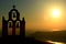 Belltower silhouette at sunset. Imerovigli, Santorini, Cyclades islands. Greece