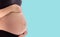Belly asia pregnant woman with blue background