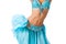 Belly dancer in a light blue costume shaking her hips
