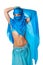 Belly dancer peeking from behind a blue veil