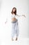 Belly dancer in white dress dancing on a white background