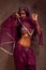 Belly-dancer woman in afghani pants, purdah and adornment