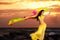 Belly Dancer in Yellow Costume on the Beach at Sunrise