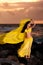 Belly Dancer in Yellow Costume on the Beach at Sunrise