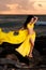 Belly Dancer in Yellow Costume on the Beach at Sunrise