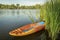 Bellyak prone kayak in reeds at lake shore