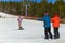 BELORETSK,RUSSIA, 13 APRIL 2019 - tourists take pictures of a male snowboarder in a funny costume with a Hawaiian guitar, closing