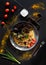 Belorussian National food - draniki. Traditional eating concept. Dark background with plate with pancake with meat with vegetables