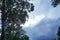 From below a background scene of a blue sky covered with overcast clouds