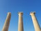 From below shot of magnificent ancient pillars standing against cloudless blue sky on sunny day.