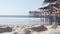 Below wooden Crystal pier on piles, ocean beach water waves, California USA.