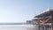 Below wooden Crystal pier on piles, ocean beach water waves, California USA.