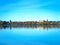 Bemidji, Minnesota reflection is seen across Lake Irving on sunny day