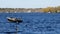 BEMIDJI, MN - 11 MAY 2019: Minnesota Fishing Opener. Motor boat speeds past fisherman on Lake Irving.