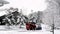 BEMIDJI, MN - 21 NOV 2019: Kubota SSV65 skid steer loader plowing new snow on a residential driveway