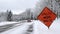 BEMIDJI, MN - 21 NOV 2019: A red car drives past a UTILITY WORK AHEAD sign warning traffic about a work crew on a snowy city