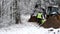 BEMIDJI, MN - 21 NOV 2019: Utility Work Crew Members discuss the project where a backhoe has dug a trench in the dirt on a frosty