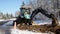 BEMIDJI, MN - 22 NOV 2019: Backhoe operator moves dirt to fill a trench at a utility work zone along a residential street on a