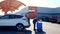 BEMIDJI, MN - 30 APR 2020: Walmart employee puts bags into car for curbside pickup of online grocery order in parking lot during