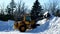 BEMIDJI, MN - 6 MAR 2019: Front end loader moves snow that has been cleared from city streets.
