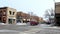 BEMIDJI, MN - 9 JAN 2020: Typical small town street scene in winter with moving vehicles and parked cars and business buildings