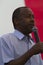 Ben Carson close up in front of a US flag, August 2015