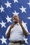 Ben Carson close up in front of a US flag stars, August 2015