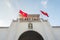 Ben Thanh Market, facade and arch of central entrance and two swaying Vietnamese flags