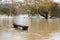 A bench becomes part of the River Mole in Brockham, Surrey, UK, as heavy rain caused flooding in December 2019