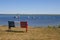 Bench and boats with French Acadian flag in Bouctouche, New Brunswick