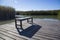 Bench casting shadow on wooden deck