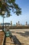 Bench on the coastal promenade along the sea under the pine. Montenegro. Budva