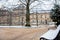 Bench covered with snow at the Luxembourg Palace garden in a freezing winter day