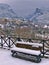 Bench covered in snow and view to Olympus mountains. Litohoro in Pieria, Greece at winter time