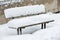 Bench covered with thick layer of snow